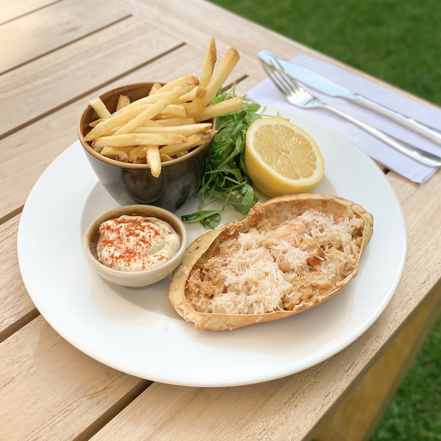 native dressed crab served in its shell with skinny fries, dressed rocket and paprika mayonnaise