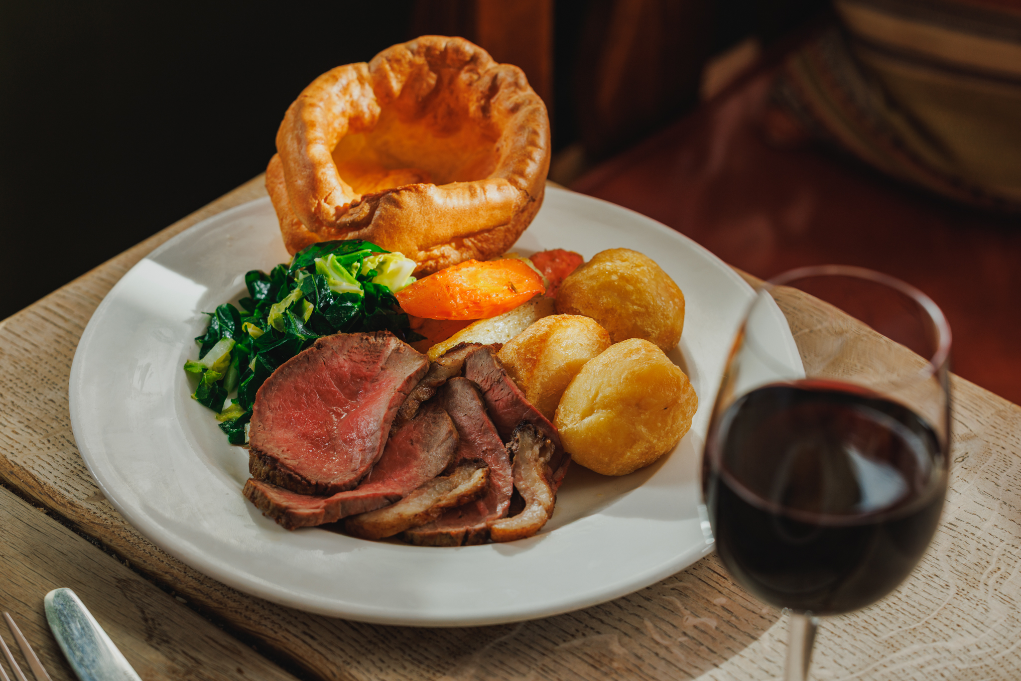 A classic Sunday Roast with beef, Yorkshire puddings and crispy potatoes