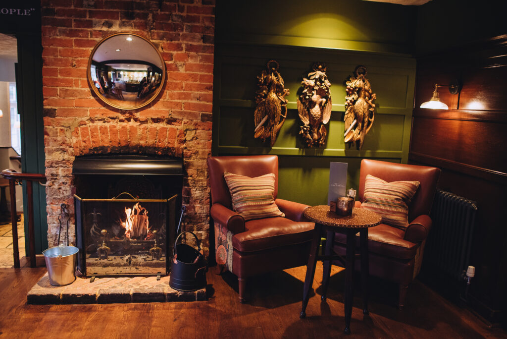 A cosy corner in a pub with a fire place